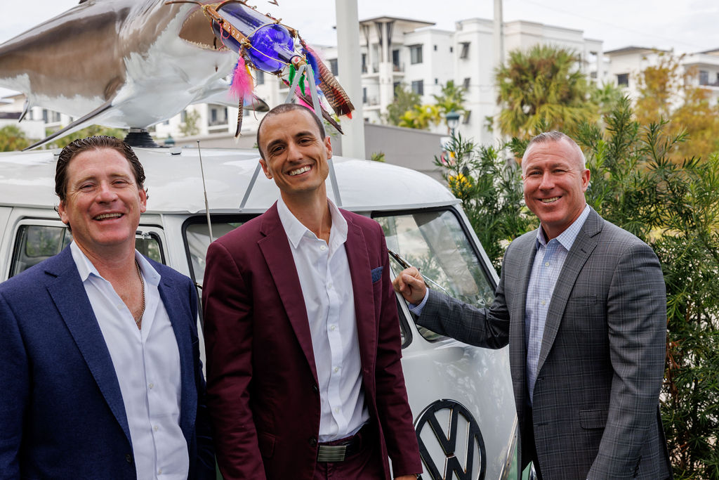 Christopher Shucart, Christopher Lee, and Marty Kenney outside by the VW van