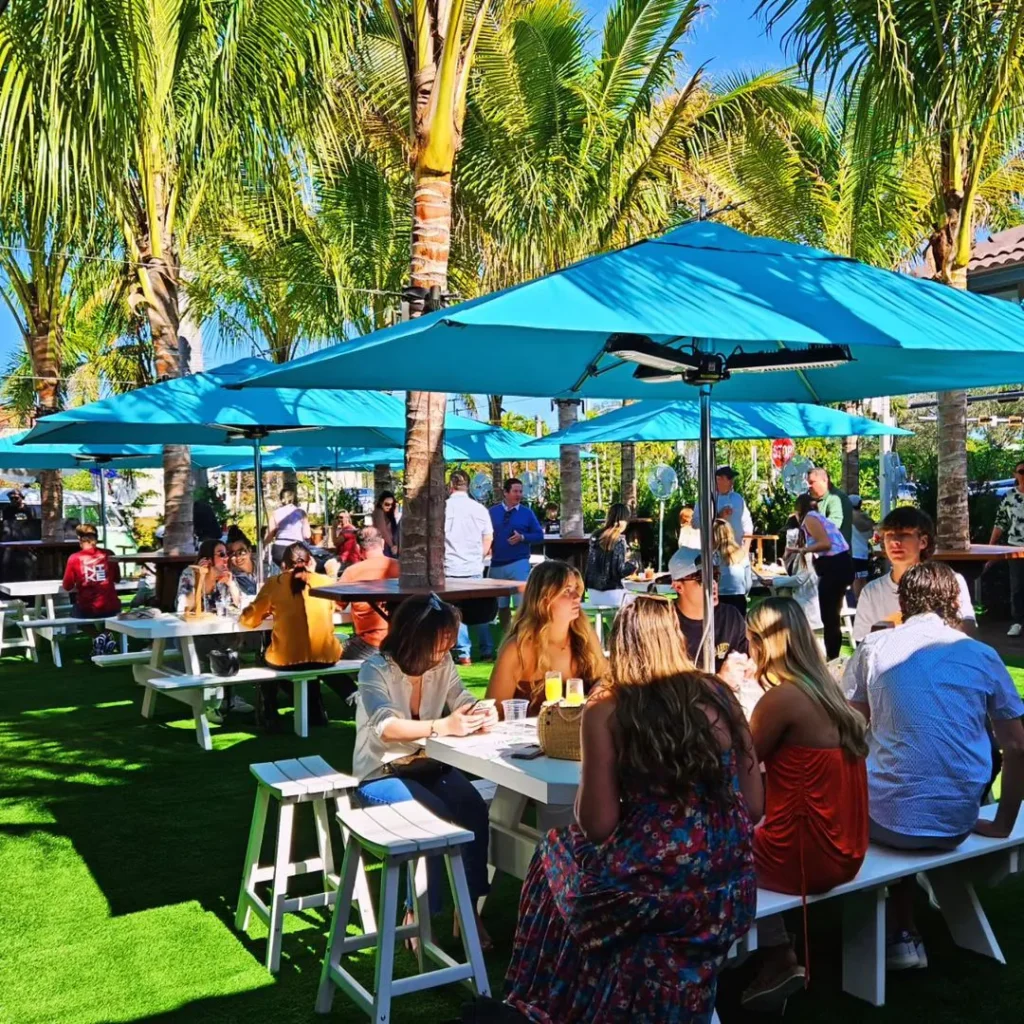 A crowd of people sitting outside in Naples at The Kitchen and The Mini Bar