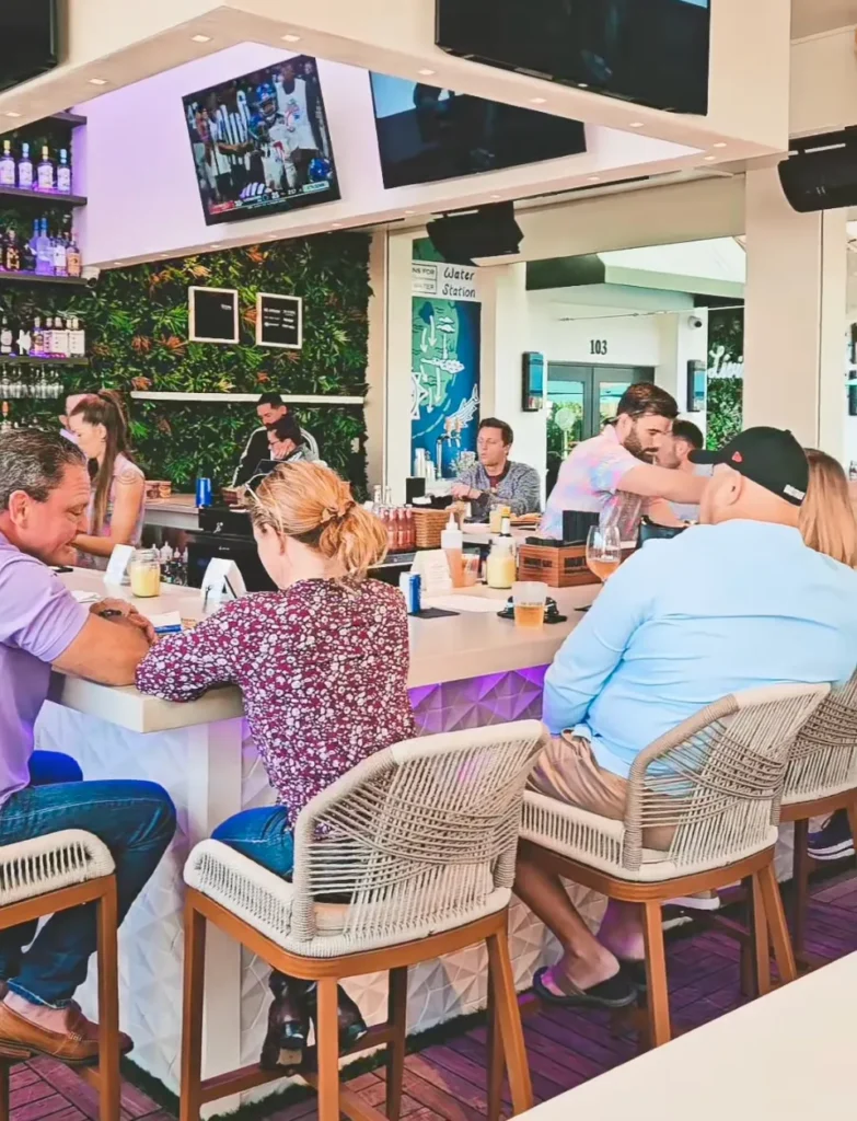 People sitting around the bar at The Kitchen and The Mini Bar